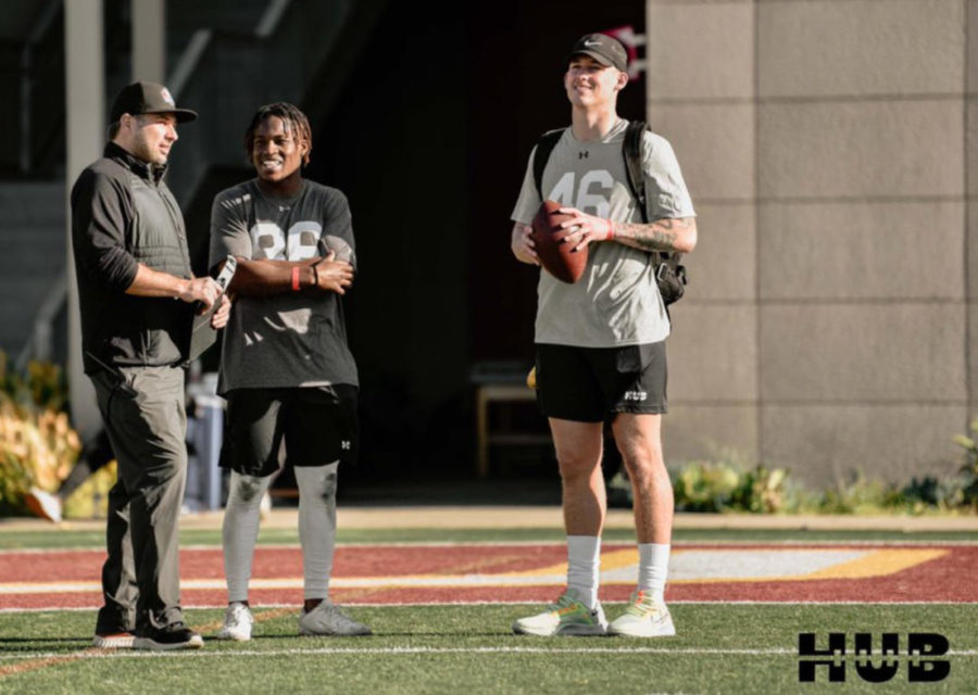 Wide+receiver%2C+Jean+Constant%2C+and+quarterback%2C+Zach+Edwards%2C+talk+to+a+Sports+Illustrated+representative+at+HUB+Football+Camp.
