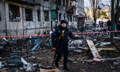 Ukrainian police guard at Kyiv apartment block bombed by Russia.